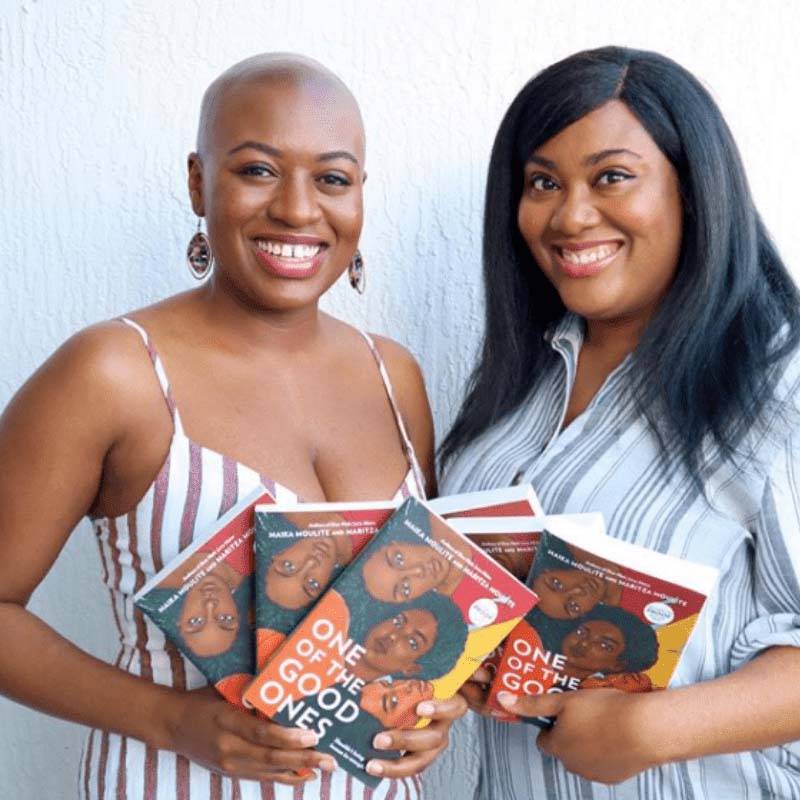 Maika and Maritza Moulite holding their book, One of the Good Ones